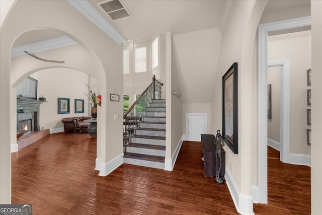 932 Shadowford Fls, Lithonia, GA 30058 - foyer with wood finished floors, a warm lit fireplace, and stairway