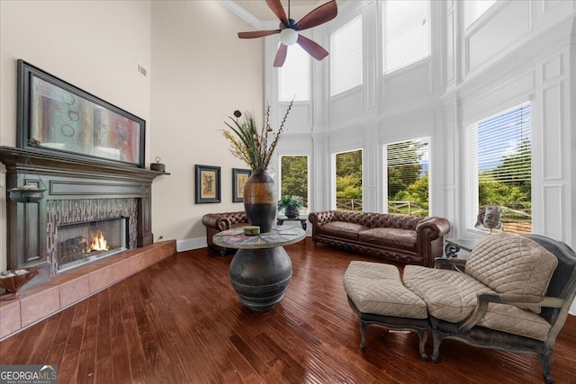 932 Shadowford Fls, Lithonia, GA 30058 - living room featuring a high ceiling, a ceiling fan, a fireplace, and hardwood / wood-style flooring