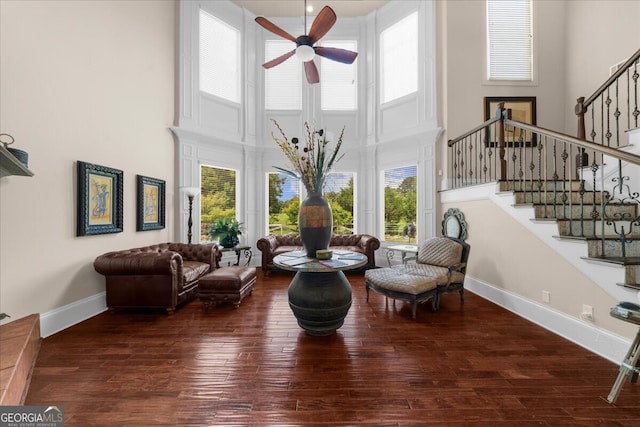 932 Shadowford Fls, Lithonia, GA 30058 - living area with a towering ceiling, a ceiling fan, stairs, and wood finished floors