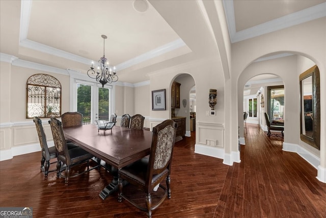 932 Shadowford Fls, Lithonia, GA 30058 - dining area with a chandelier, arched walkways, hardwood / wood-style flooring, a tray ceiling, and ornamental molding