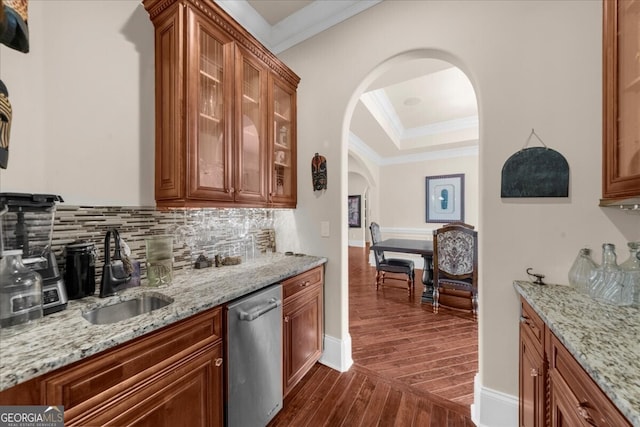 932 Shadowford Fls, Lithonia, GA 30058 - kitchen with stainless steel dishwasher, arched walkways, dark wood-style floors, crown molding, and light stone counters