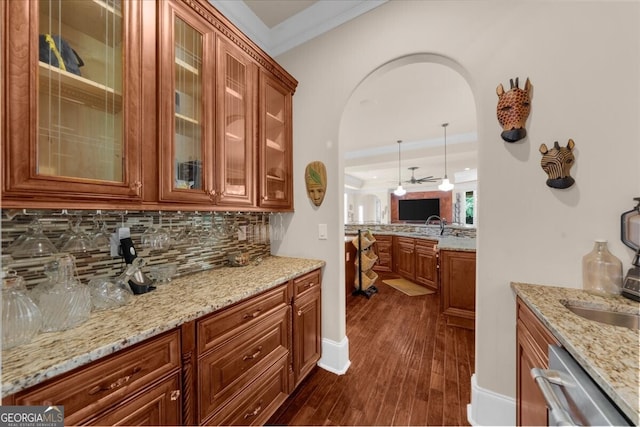 932 Shadowford Fls, Lithonia, GA 30058 - bar area with arched walkways, decorative backsplash, ceiling fan, dark wood-style floors, and crown molding