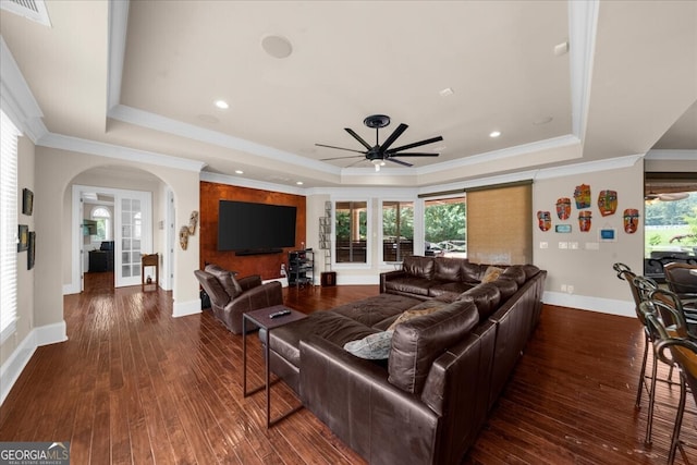 932 Shadowford Fls, Lithonia, GA 30058 - living room with a tray ceiling, a ceiling fan, hardwood / wood-style flooring, arched walkways, and ornamental molding