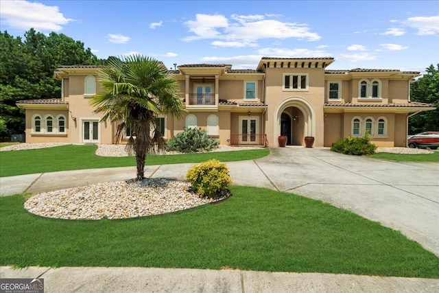 932 Shadowford Fls, Lithonia, GA 30058 - mediterranean / spanish-style home featuring french doors, curved driveway, a balcony, and a front yard