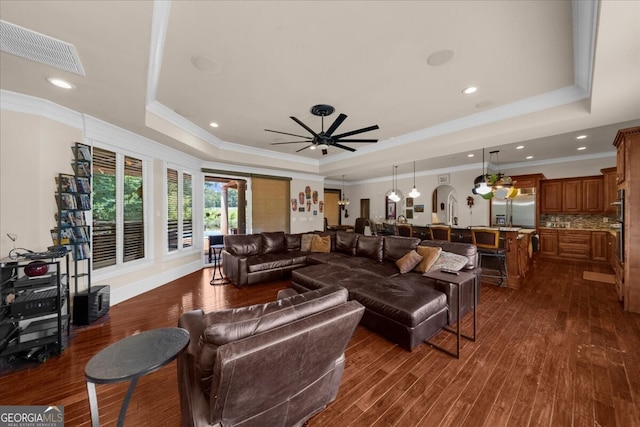 932 Shadowford Fls, Lithonia, GA 30058 - living area with a tray ceiling, crown molding, ceiling fan, dark wood-style flooring, and recessed lighting