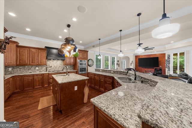 932 Shadowford Fls, Lithonia, GA 30058 - kitchen with premium range hood, a spacious island, decorative backsplash, ceiling fan, and open floor plan