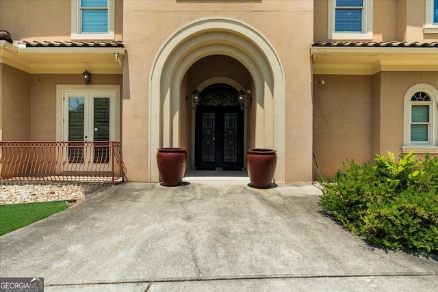 932 Shadowford Fls, Lithonia, GA 30058 - entrance to property featuring french doors, stucco siding, and a tile roof