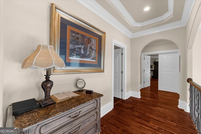 932 Shadowford Fls, Lithonia, GA 30058 - hallway featuring dark wood-type flooring, ornamental molding, arched walkways, and a raised ceiling