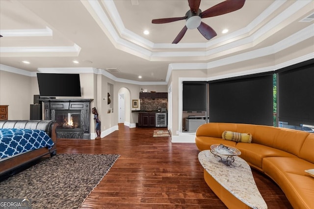 932 Shadowford Fls, Lithonia, GA 30058 - living area with beverage cooler, crown molding, a raised ceiling, ceiling fan, and wood finished floors
