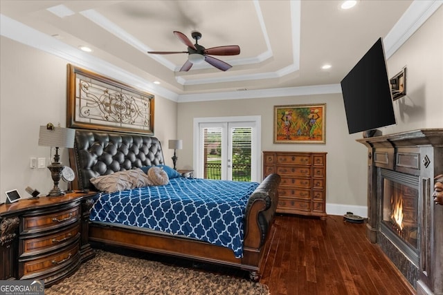 932 Shadowford Fls, Lithonia, GA 30058 - bedroom featuring a glass covered fireplace, a tray ceiling, ornamental molding, access to outside, and hardwood / wood-style floors