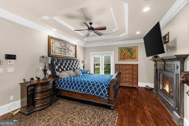932 Shadowford Fls, Lithonia, GA 30058 - bedroom featuring a raised ceiling, a glass covered fireplace, crown molding, hardwood / wood-style flooring, and recessed lighting