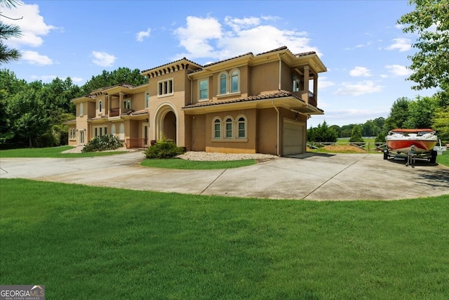 932 Shadowford Fls, Lithonia, GA 30058 - mediterranean / spanish-style home with stucco siding, a tiled roof, driveway, a garage, and a front yard