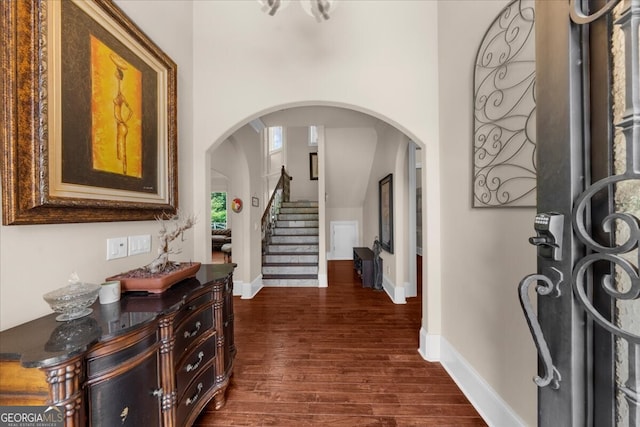 932 Shadowford Fls, Lithonia, GA 30058 - foyer with dark wood-type flooring, arched walkways, and stairway