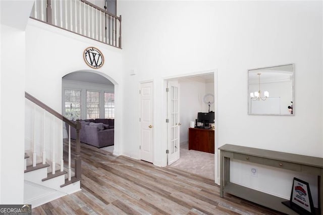 2516 Woolwich Ct, Acworth, GA 30101 - entryway featuring arched walkways, a high ceiling, wood finished floors, french doors, and stairway