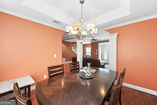 2670 Trotters Pointe Dr, Snellville, GA 30039 - dining area with decorative columns, a ceiling fan, a tray ceiling, wood finished floors, and arched walkways