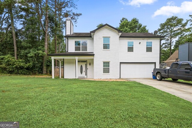 2670 Trotters Pointe Dr, Snellville, GA 30039 - traditional-style house featuring a garage, driveway, a chimney, a front lawn, and covered porch