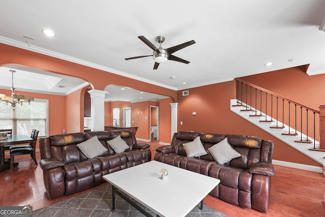 2670 Trotters Pointe Dr, Snellville, GA 30039 - living area with ornate columns, wood finished floors, ceiling fan, arched walkways, and crown molding