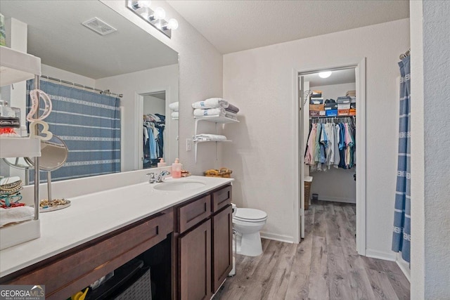 255 Morning Dr, Athens, GA 30606 - bathroom featuring a walk in closet, vanity, wood finished floors, and a shower with shower curtain