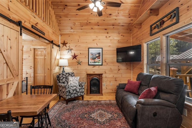 72 Bentley Cv, Murphy, NC 28960 - living area with a barn door, a ceiling fan, wood walls, and wooden ceiling