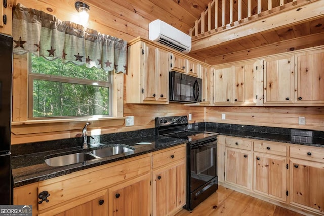 72 Bentley Cv, Murphy, NC 28960 - kitchen featuring black appliances, an AC wall unit, light brown cabinets, dark stone countertops, and light wood-type flooring