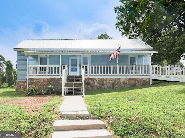 79 Hillside St, Nelson, GA 30151 - view of front of house with covered porch, a front lawn, a metal roof, stairs, and stone siding