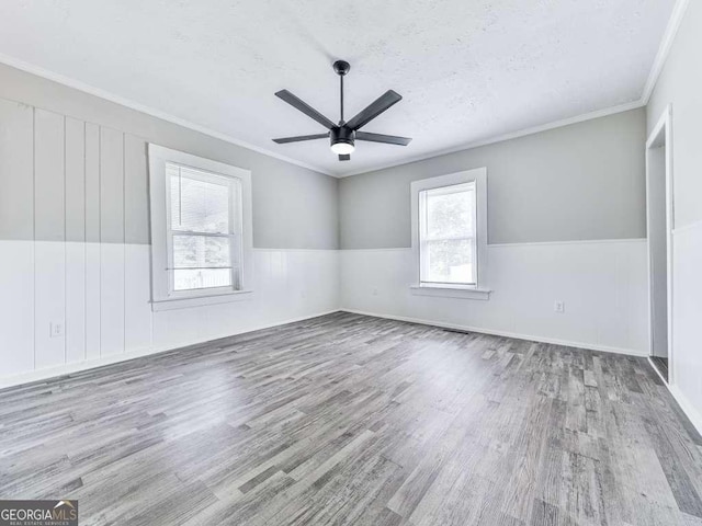 79 Hillside St, Nelson, GA 30151 - unfurnished room featuring wood finished floors, a ceiling fan, a wainscoted wall, ornamental molding, and a textured ceiling