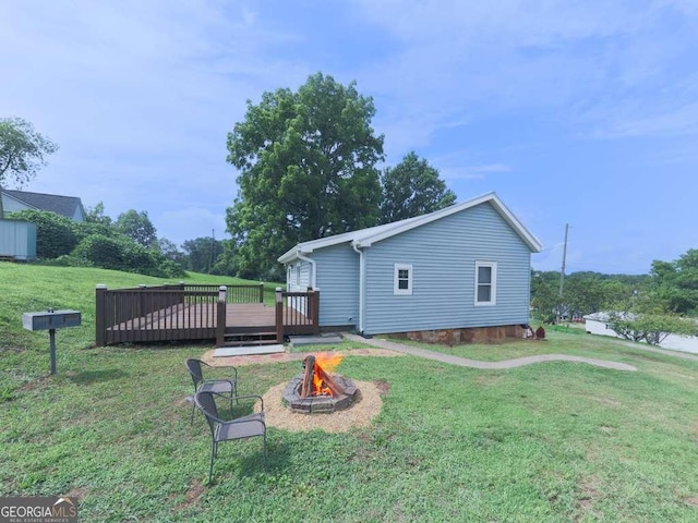 79 Hillside St, Nelson, GA 30151 - back of house with an outdoor fire pit, a wooden deck, and a lawn
