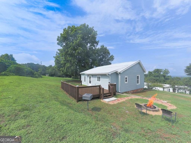 79 Hillside St, Nelson, GA 30151 - view of green lawn with a fire pit and a wooden deck
