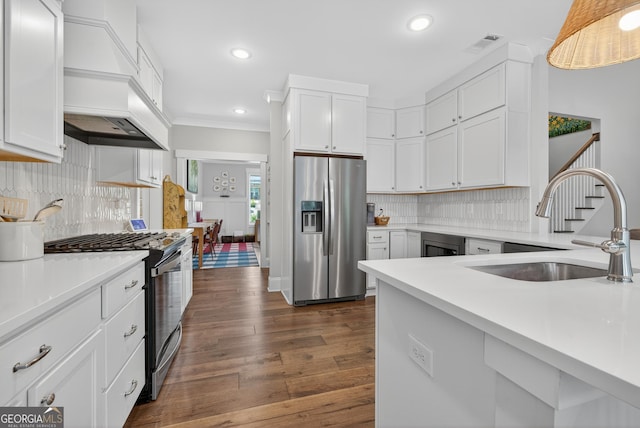 1145 Summerfield Ln, Bogart, GA 30622 - kitchen with appliances with stainless steel finishes, custom range hood, light countertops, recessed lighting, and white cabinetry