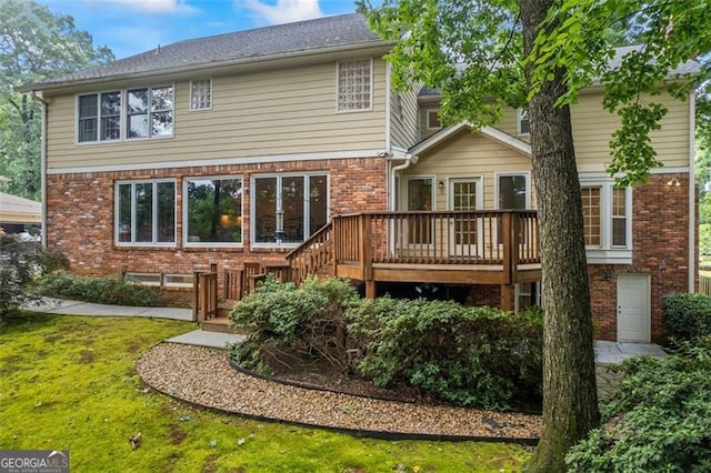 1416 Vernon Rdg, Close, Dunwoody, GA 30338 - back of house with brick siding, a wooden deck, and a lawn