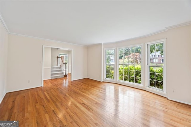1416 Vernon Rdg, Close, Dunwoody, GA 30338 - unfurnished room featuring plenty of natural light, ornamental molding, light wood finished floors, and stairs