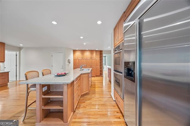 1416 Vernon Rdg, Close, Dunwoody, GA 30338 - kitchen featuring stainless steel appliances, open shelves, a kitchen breakfast bar, light wood-style flooring, and recessed lighting