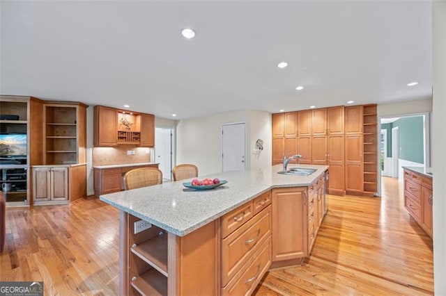 1416 Vernon Rdg, Close, Dunwoody, GA 30338 - kitchen featuring open shelves, light wood finished floors, recessed lighting, a large island, and light stone counters