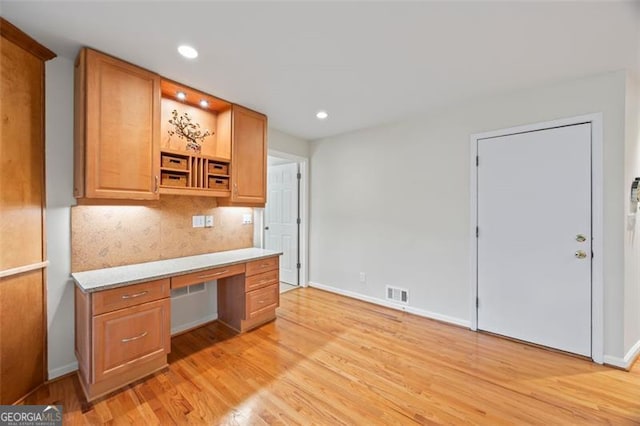 1416 Vernon Rdg, Close, Dunwoody, GA 30338 - kitchen featuring built in desk, light wood-style flooring, decorative backsplash, light countertops, and open shelves