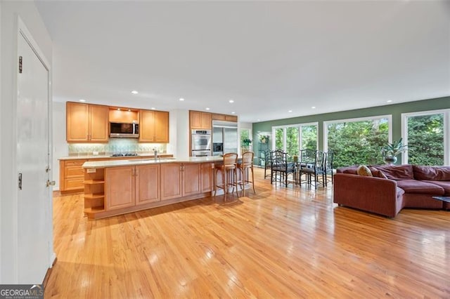 1416 Vernon Rdg, Close, Dunwoody, GA 30338 - kitchen with stainless steel appliances, open shelves, light wood-style floors, plenty of natural light, and recessed lighting