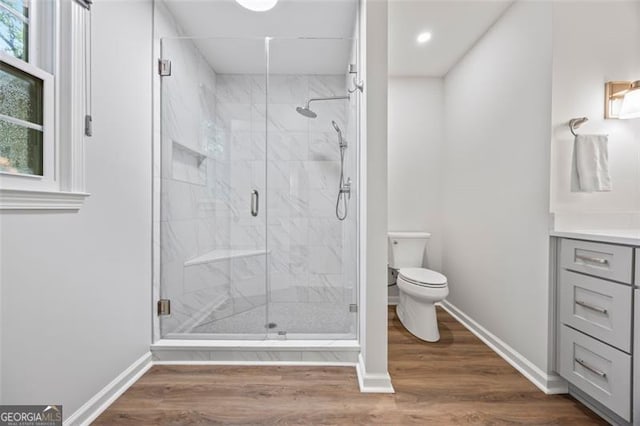1416 Vernon Rdg, Close, Dunwoody, GA 30338 - bathroom featuring vanity, a marble finish shower, wood finished floors, and recessed lighting