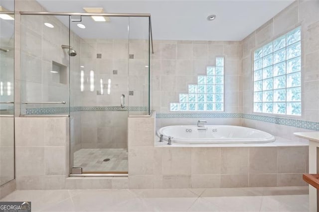 1416 Vernon Rdg, Close, Dunwoody, GA 30338 - bathroom featuring a garden tub, a stall shower, tile walls, tile patterned flooring, and recessed lighting