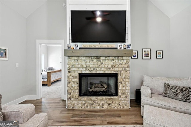 161 Fairway Cir, Macon, GA 31211 - living room featuring wood finished floors, a brick fireplace, and high vaulted ceiling