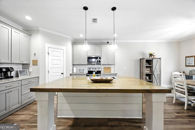 161 Fairway Cir, Macon, GA 31211 - kitchen with appliances with stainless steel finishes, gray cabinets, ornamental molding, wooden counters, and tasteful backsplash