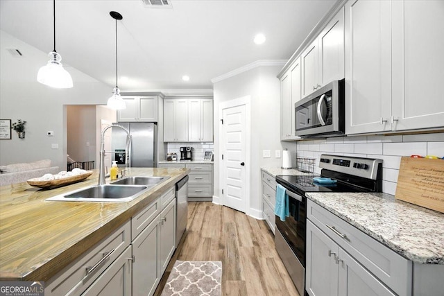 161 Fairway Cir, Macon, GA 31211 - kitchen with appliances with stainless steel finishes, decorative backsplash, ornamental molding, decorative light fixtures, and recessed lighting