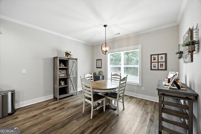 161 Fairway Cir, Macon, GA 31211 - dining area with dark wood finished floors, ornamental molding, and a chandelier