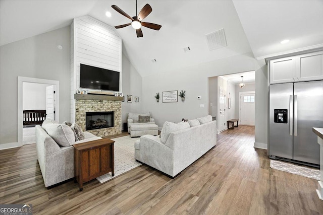 161 Fairway Cir, Macon, GA 31211 - living area with high vaulted ceiling, a ceiling fan, wood finished floors, a stone fireplace, and recessed lighting