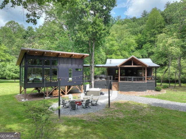 211 Rockhouse Rd, Cherry Log, GA 30522 - view of green lawn with a fire pit and a wooded view