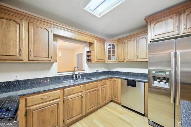 171 Loraine Forest Dr, Macon, GA 31210 - kitchen featuring stainless steel appliances, light wood-style flooring, dark stone countertops, and brown cabinetry