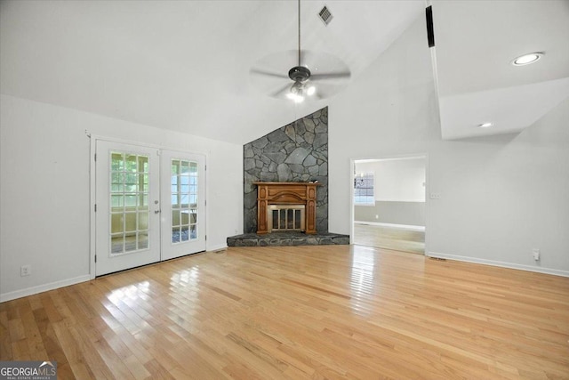 171 Loraine Forest Dr, Macon, GA 31210 - unfurnished living room with a ceiling fan, wood finished floors, french doors, a stone fireplace, and high vaulted ceiling
