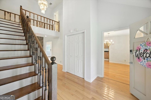 171 Loraine Forest Dr, Macon, GA 31210 - stairway featuring a chandelier, a towering ceiling, and wood finished floors