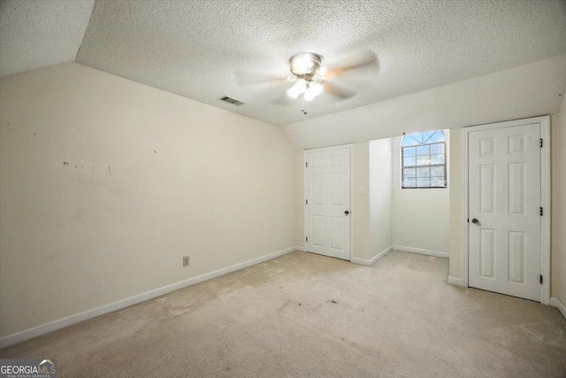 171 Loraine Forest Dr, Macon, GA 31210 - unfurnished bedroom with lofted ceiling, light colored carpet, a textured ceiling, and a ceiling fan