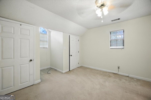171 Loraine Forest Dr, Macon, GA 31210 - unfurnished bedroom with light carpet, lofted ceiling, a textured ceiling, and a ceiling fan