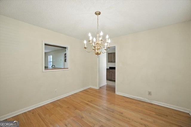 171 Loraine Forest Dr, Macon, GA 31210 - unfurnished room with a chandelier and light wood-type flooring