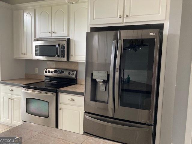 550 Masters Cir, Dublin, GA 31021 - kitchen featuring stainless steel appliances, white cabinetry, and tile patterned flooring